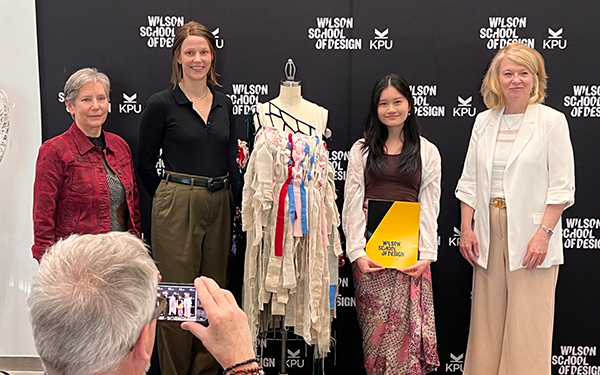 Clara with first place garment and judges from the Our Social Fabric Upcycled Competition 2024