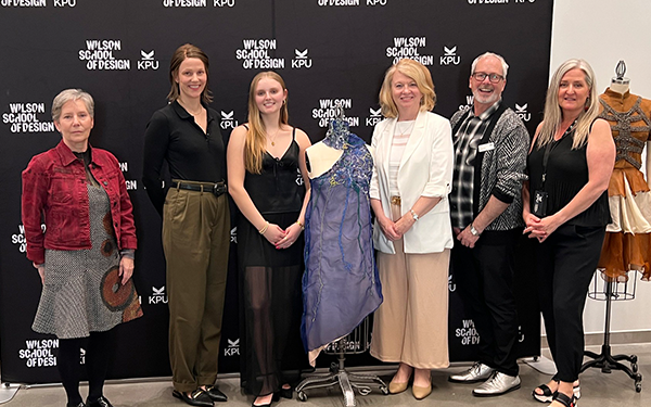 Sophie standing with her final dress and the judges for the Our Social Fabric Upcycled Competition 2024