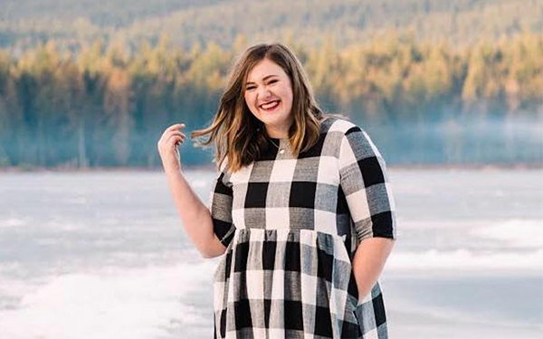 Photo of Alyssa in a check dress by a lake