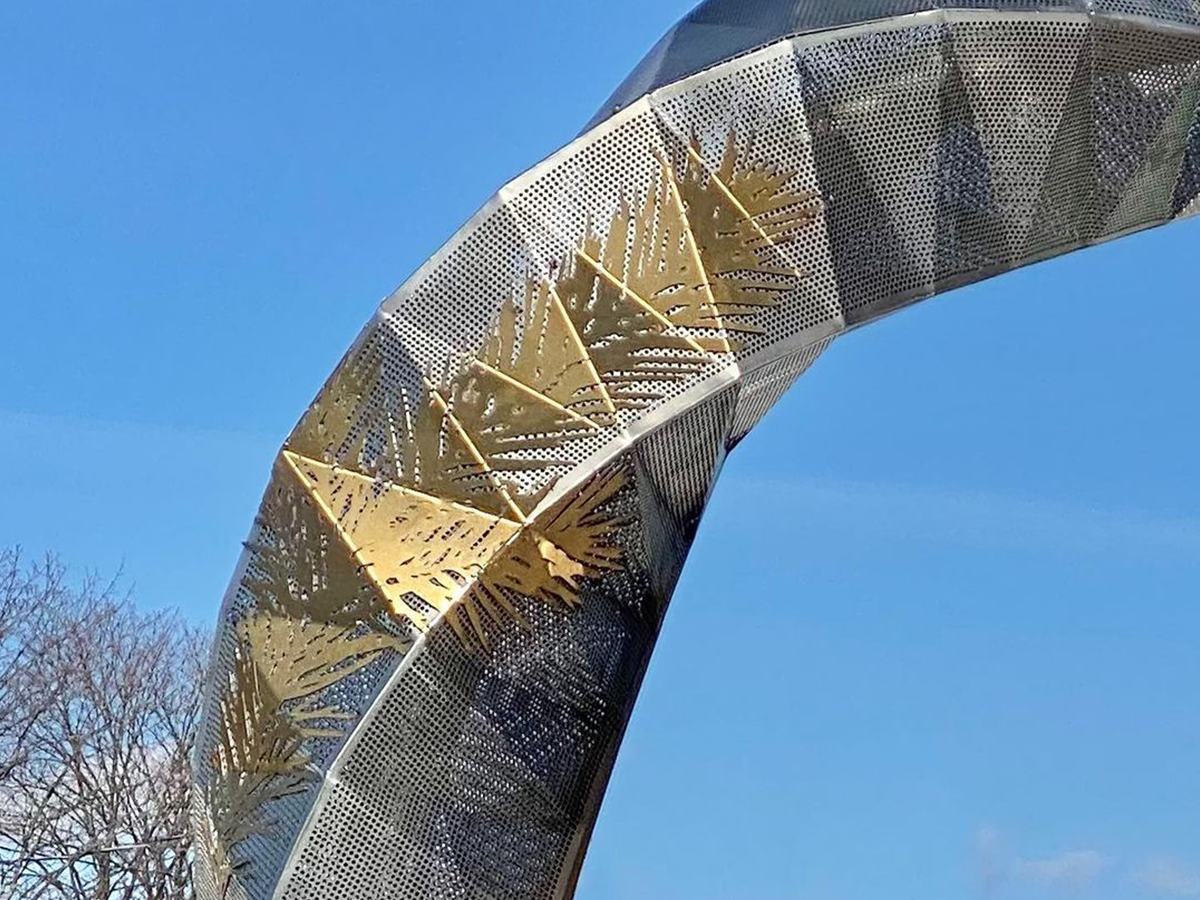 Close up on leaf and branch details in gold on the metal cauldron